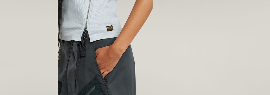 canotta aderente con zip asimmetrica